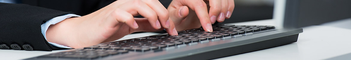 A photo of an individual typing on a keyboard